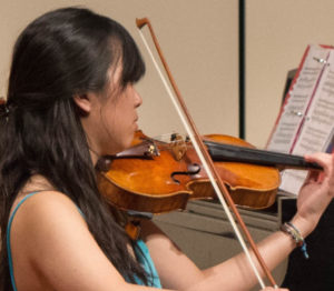 Bachelor in Music student practicing violin composition.