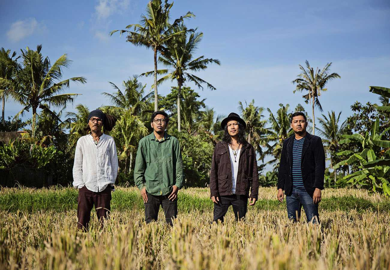 band in field posing for cover photo