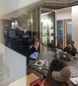 people meeting, visible through a window with frosted square
