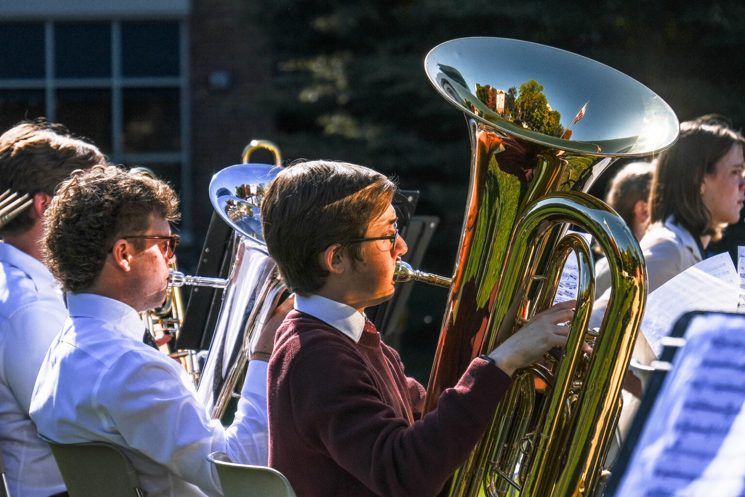 music students playing horn instruments outdoors