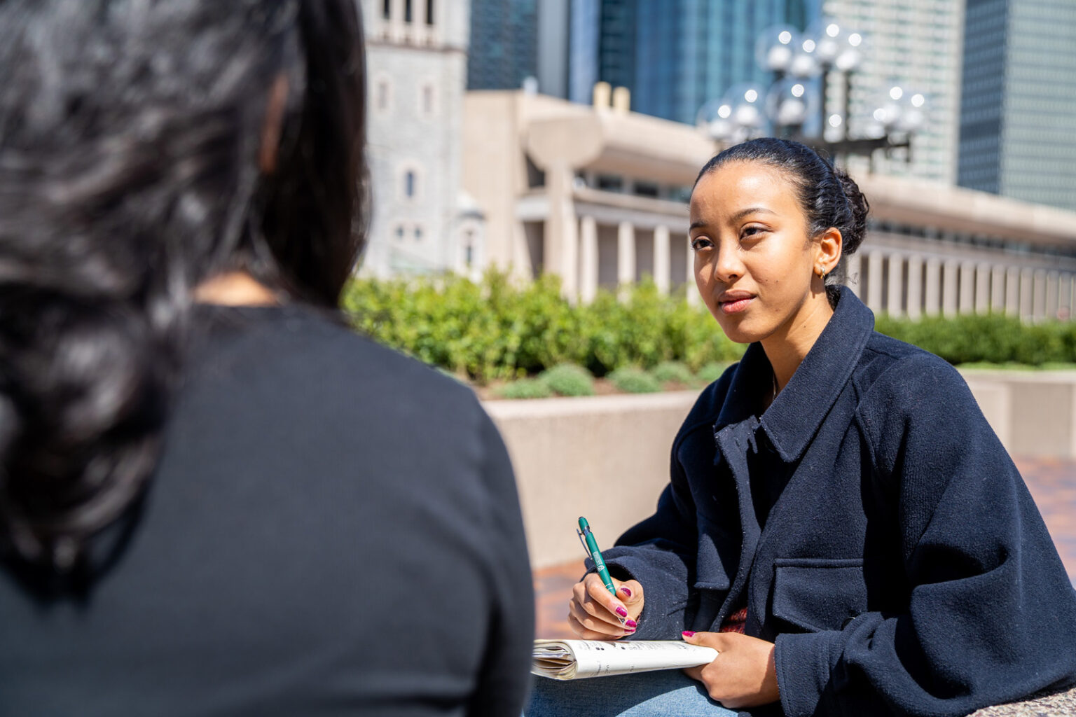 woman taking notes outdoors