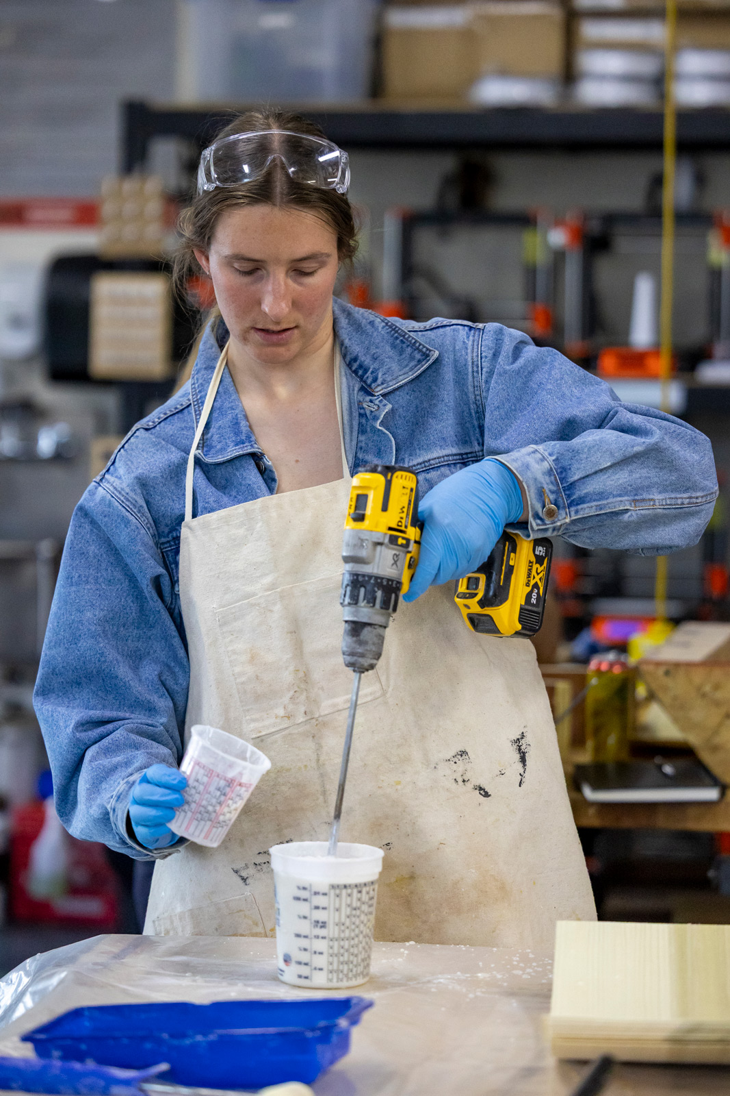 woman in apron working in the makerspace
