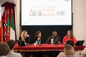 Wide angle view of a conference setting. Okereke speaks in 2023 at the International Journalism Festival (the world’s largest journalism festival). 