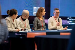 Professor Christopher Le Dantec speaks on a panel with three other professors. 